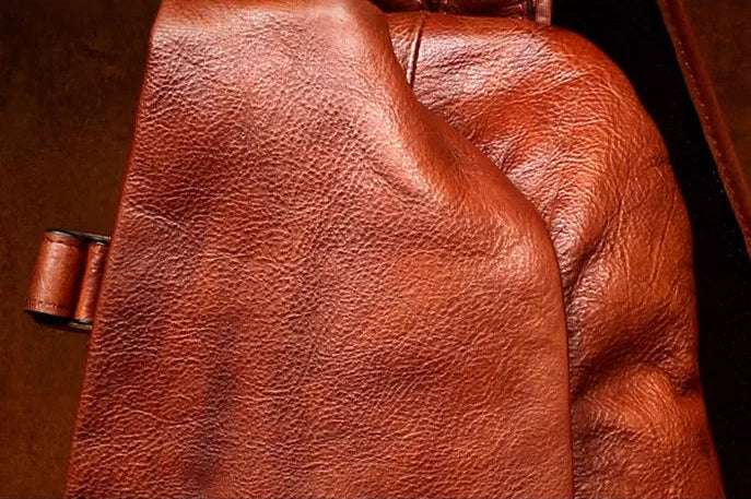 Close-up of rich brown leather texture showcasing its natural grain and softness.