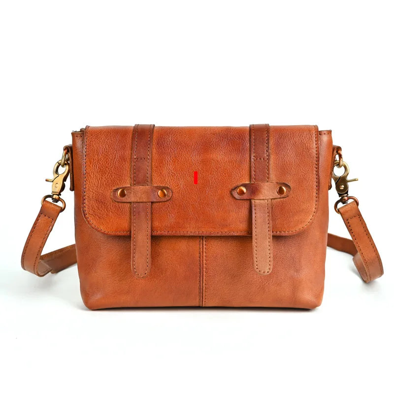 A minimalist brown leather shoulder bag featuring a flap closure - front view.