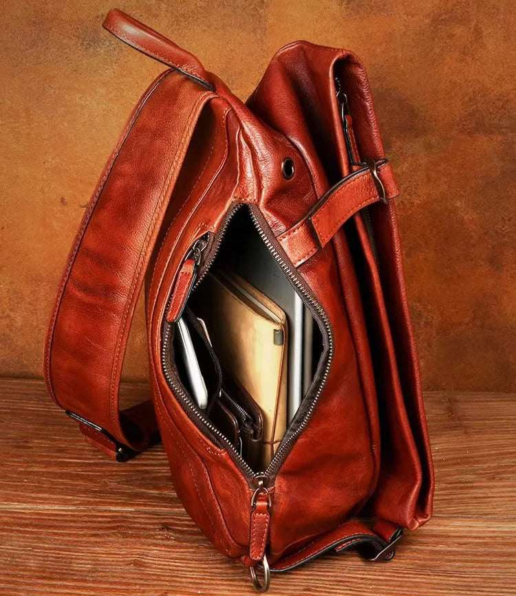 Open brown leather shoulder bag showing interior compartment with multiple items inside.