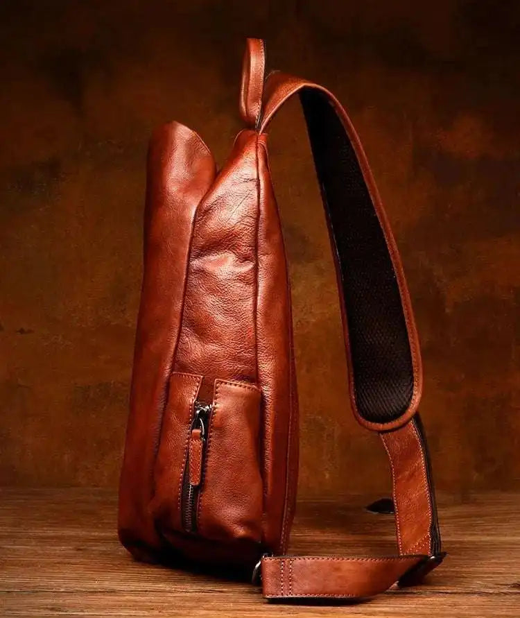 side view of stylish brown leather shoulder bag with a sleek design.