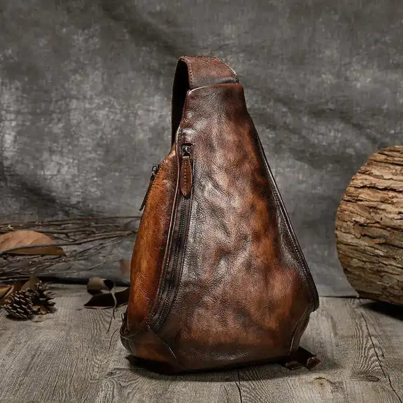 vintage brown leather shoulder bag with a unique triangular design -front view.