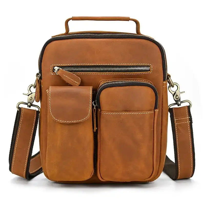 brown leather suitcase with multiple compartments and adjustable strap, ideal for a laptop or daily use - front view.