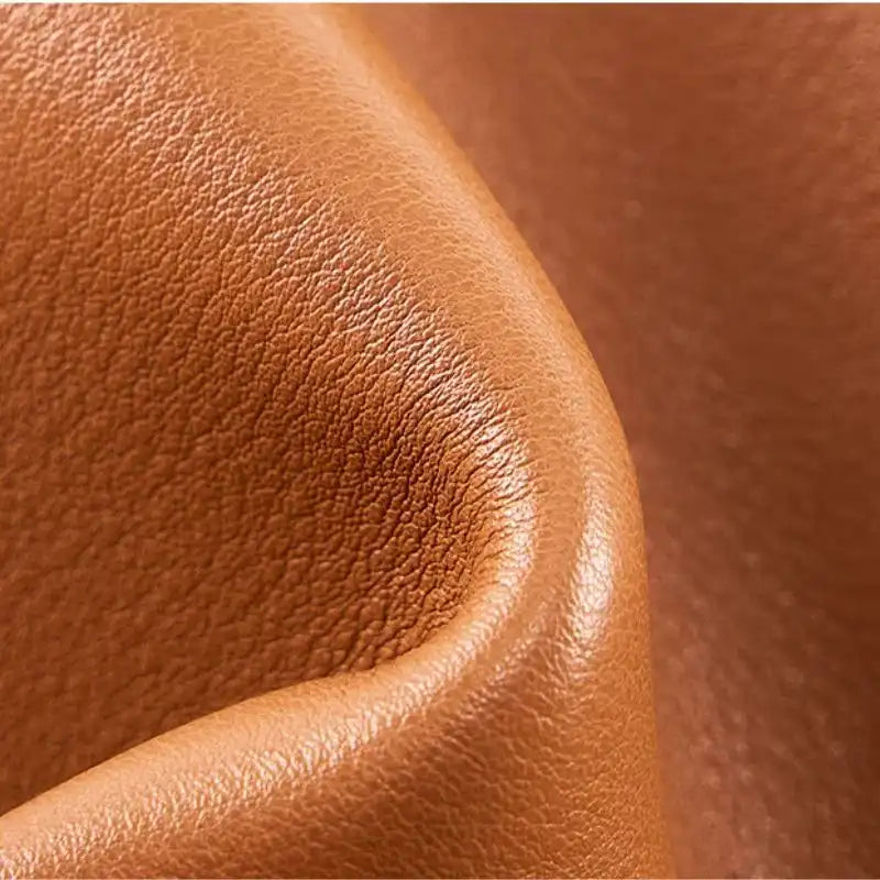 Detail of a high quality leather with a smooth texture and brown color.