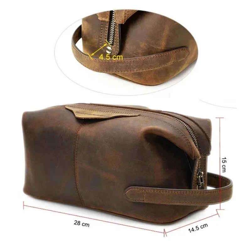 Brown leather toiletry bag with zipper closure and soft handle, measuring 28cm wide, 15cm high and 14.5cm deep.