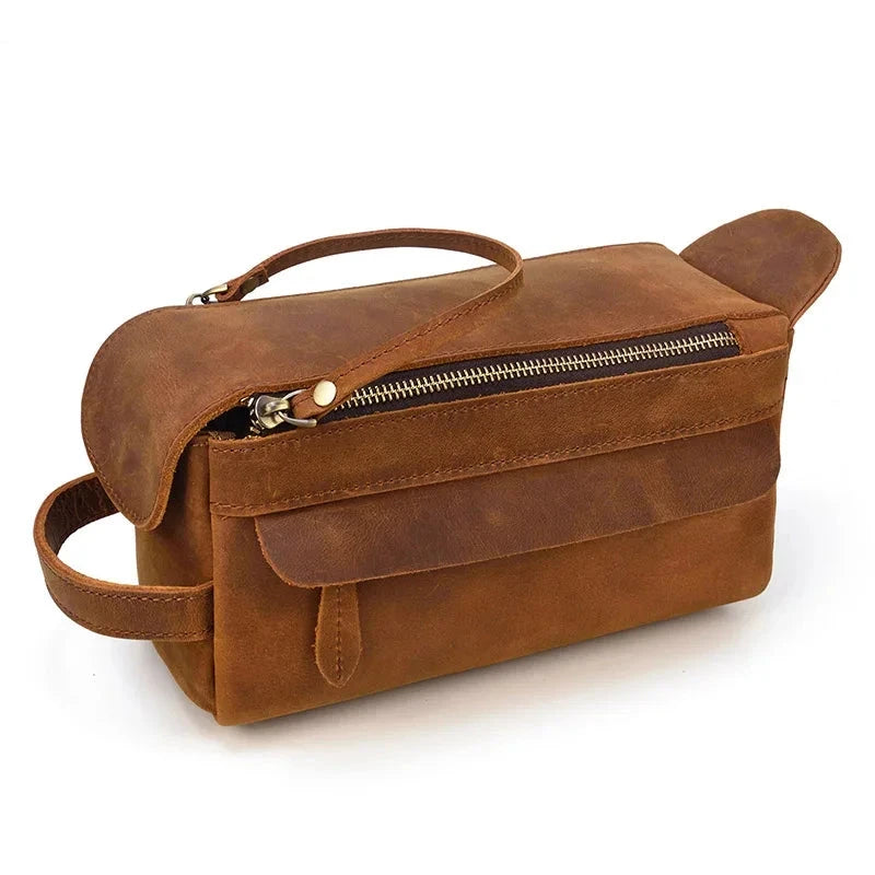 Brown leather toiletry bag with zipper and carrying handle, ideal for organizing makeup and personal care items.