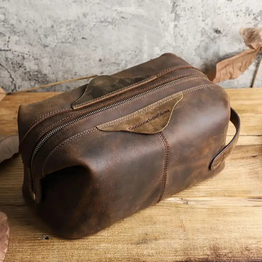 Brown leather toiletry bag with zipper closure, ideal for storing personal items, top view.