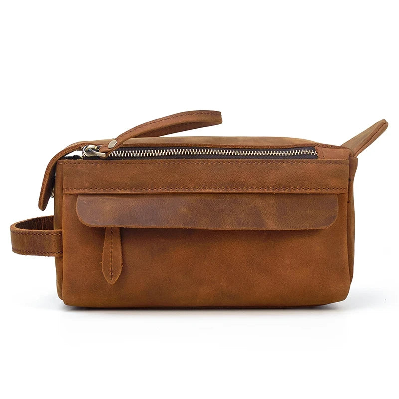 side view of a brown leather clutch with a flap and side zipper pocket.