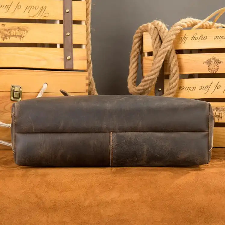Close-up of the bottom of a rustic leather tote bag featuring the soft surface.
