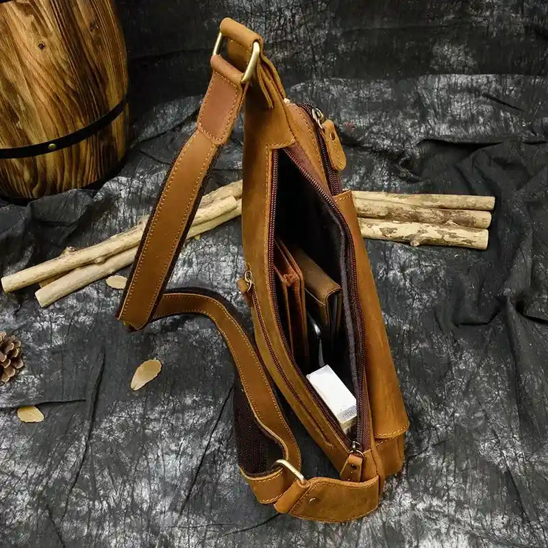 Interior view of a brown crossbody bag with compartments for organization.