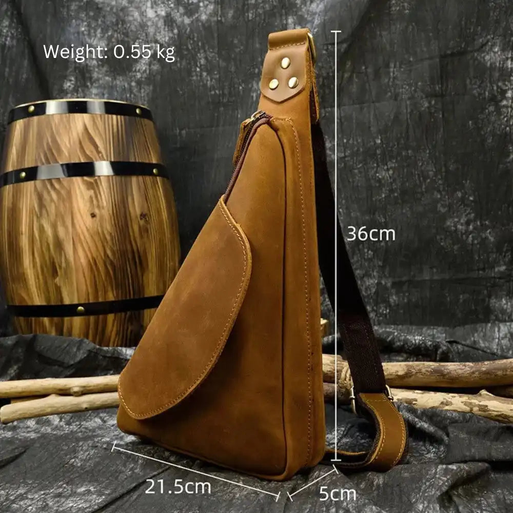 Side view of a brown leather sling bag with dimensions.