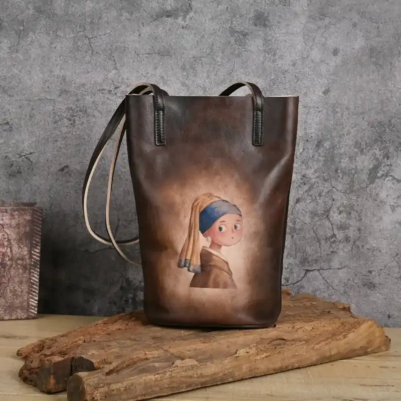 brown leather tote bag with artwork of the girl with the pearl earring, front view.