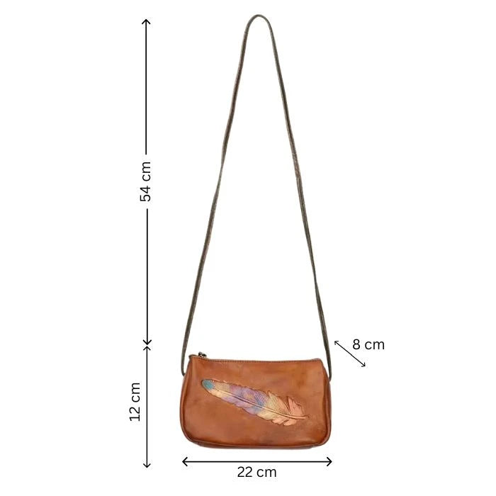 Brown leather crossbody bag with colored feather detail and long strap, measures 22 cm wide, 12 cm high and 8 cm deep, front view.