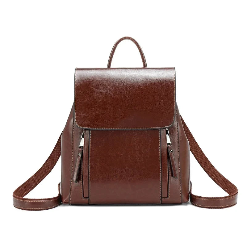 Stylish brown leather backpack with dual zippers and adjustable straps - front view.