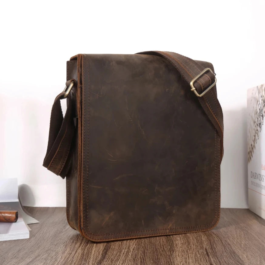 Coffee brown leather crossbody bag, casual style, with minimalistic design and adjustable strap, front view.