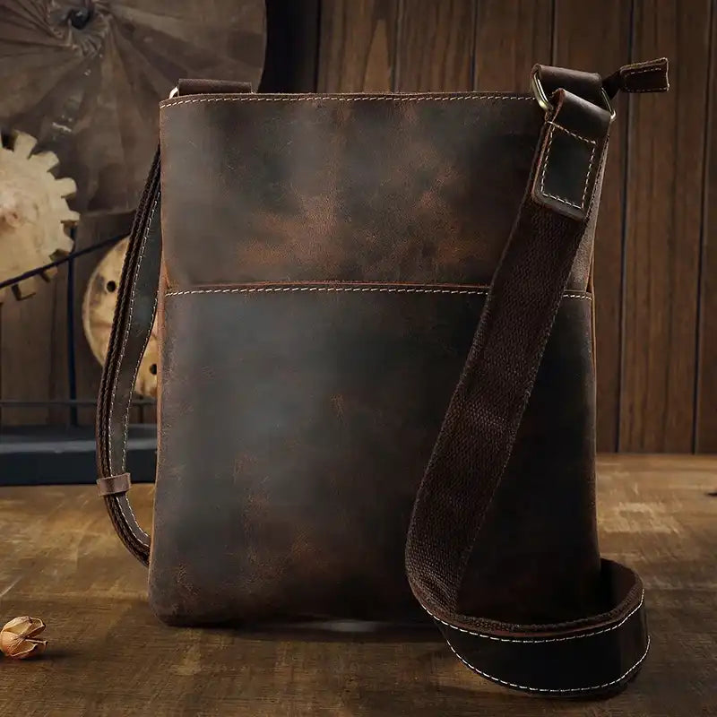 Coffee brown leather crossbody bag, with adjustable strap, stylish design and ample space for essentials - front view.