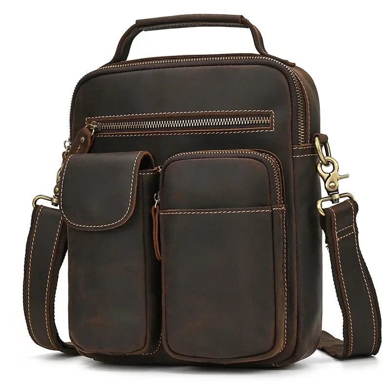 coffee brown leather suitcase with multiple compartments, detachable strap and soft handle - front view.