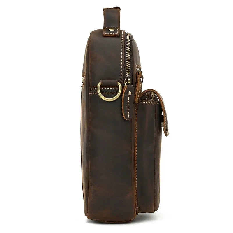 coffee brown leather suitcase with back zipped compartment and soft handle - side view.
