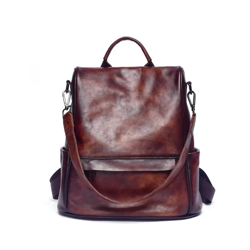 Vintage-inspired coffee brown leather backpack with anti-theft design, detachable strap and soft handle.