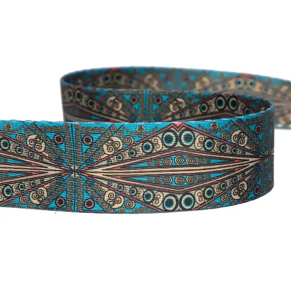 Colorful decorative bag strap with vibrant prints in blue, brown and gold details.