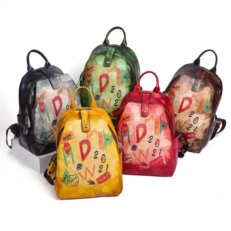 display of colorful leather backpacks with artistic prints.