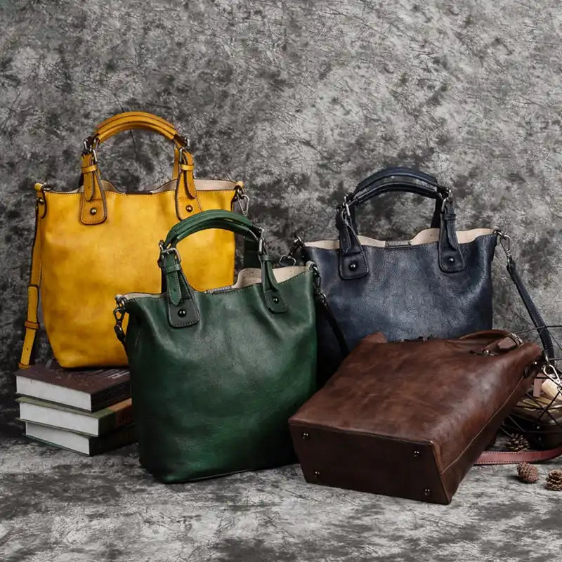 Set of four colorful leather bags on a neutral background, highlighting different colors in yellow, green, blue and brown.