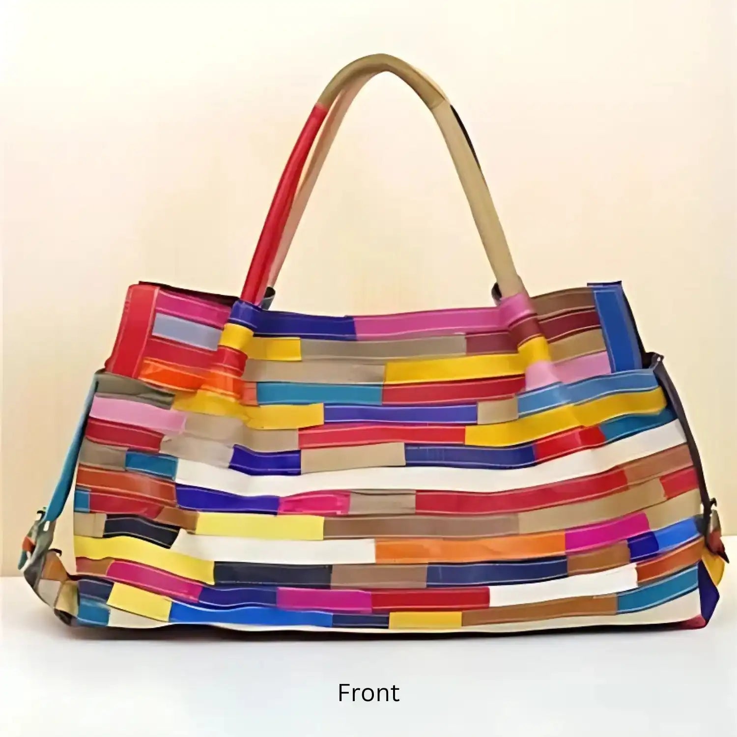 A fashionable leather tote bag with a multi-colored striped pattern, perfect for any outfit, front view.
