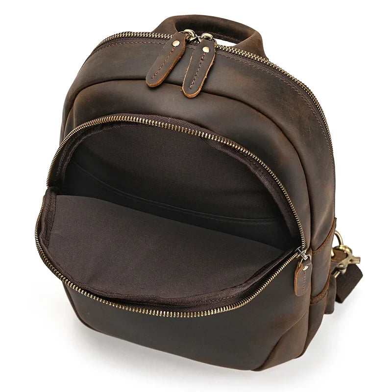 open brown leather bag showing  large front compartment.