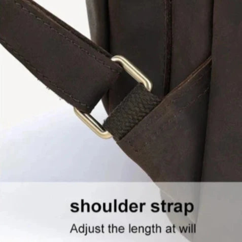 Close-up of an adjustable leather shoulder strap with metal hardware.