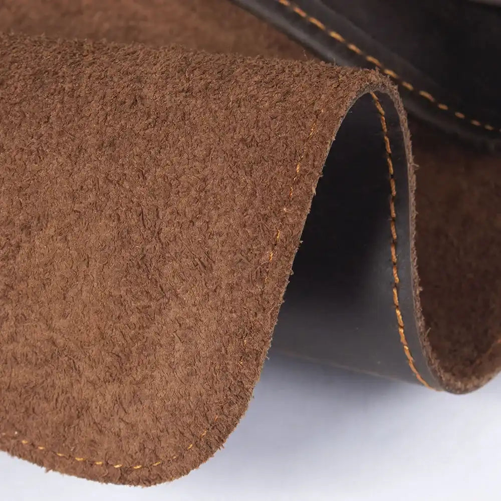 Close-up of brown leather texture with fine stitching.