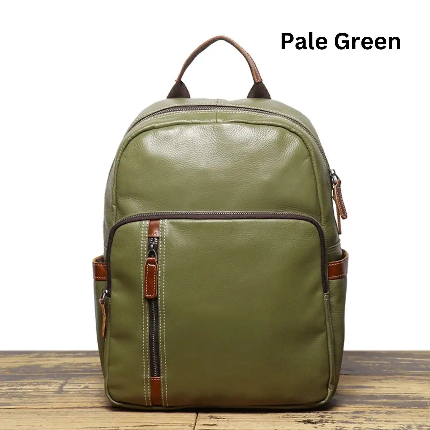 Pale green leather backpack, with an elegant finish and practical front compartments, front view.