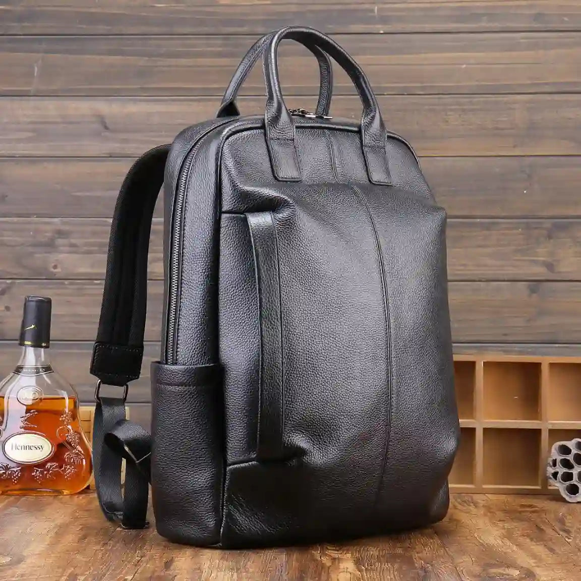 Modern black backpack showcasing a minimalist style with straps and handle.