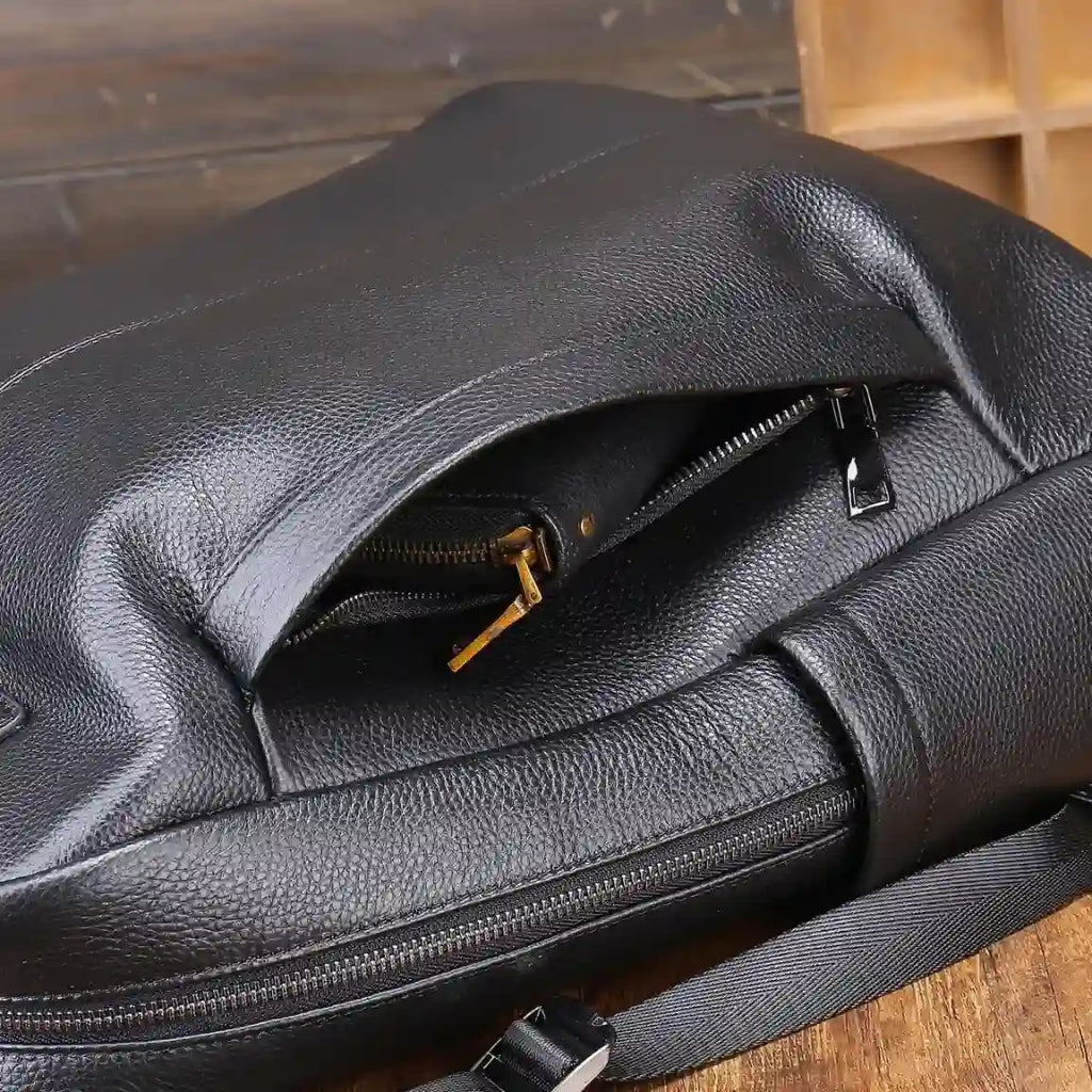 Stylish black leather bag showcasing its texture and zipper details.