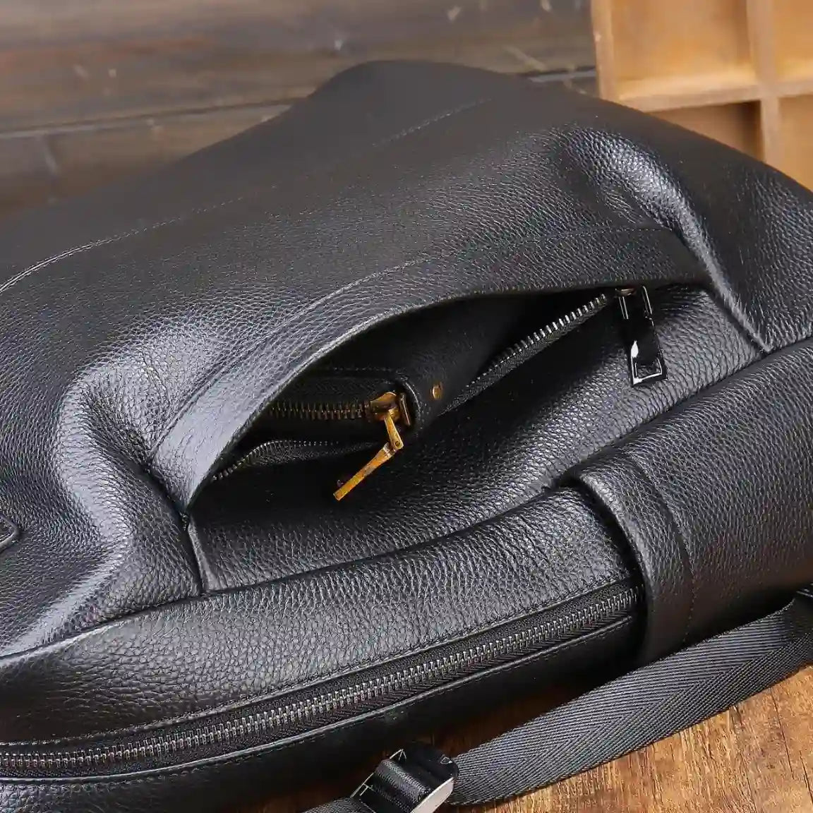 Stylish black leather bag showcasing its texture and zipper details.