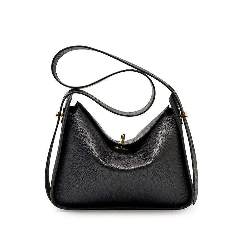 Elegant black leather bag, with a modern design and long adjustable strap creating a casual look, front view.