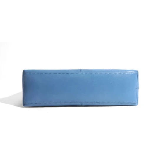 Elegant blue leather bag with a modern design and adjustable strap, bottom view.