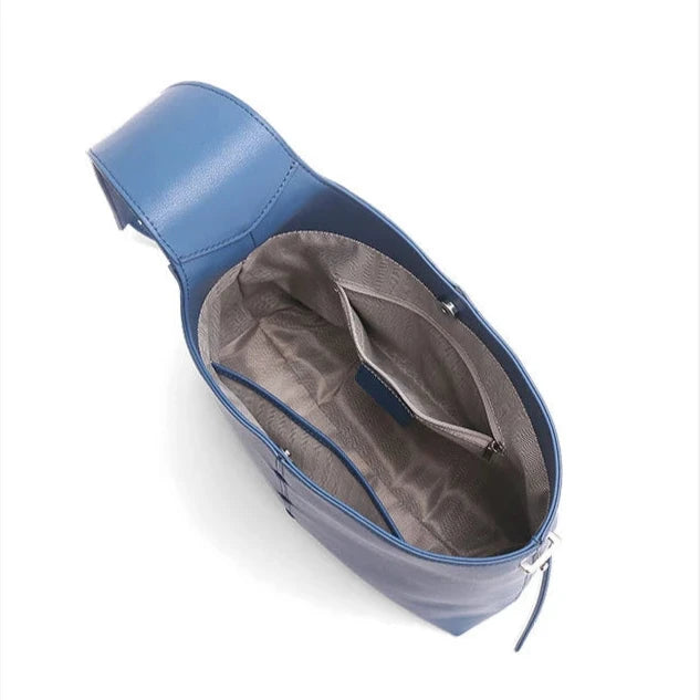 interior view of a blue leather bags, highlighting interior compartment and pockets.