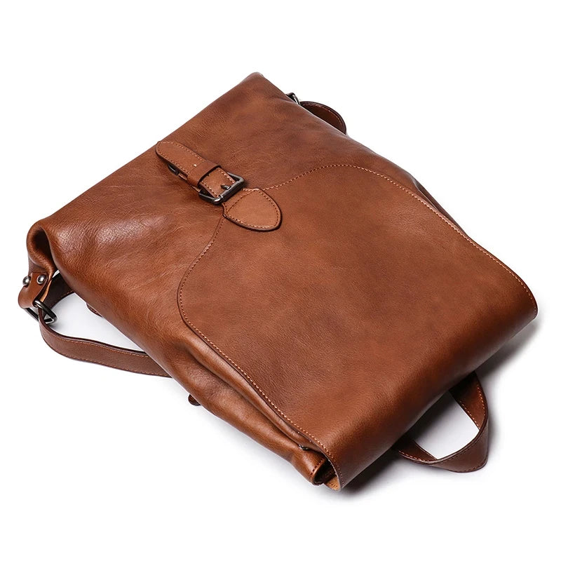 Vintage style brown leather bag with adjustable straps and elegant buckle - top view.