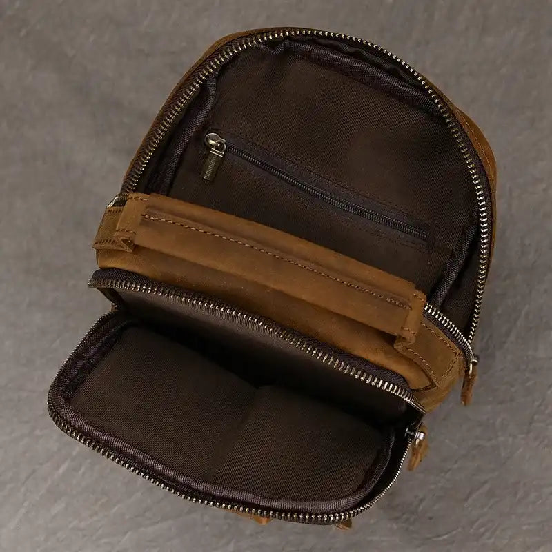 inside view of a brown backpack, showing the compartments and zipper details. 