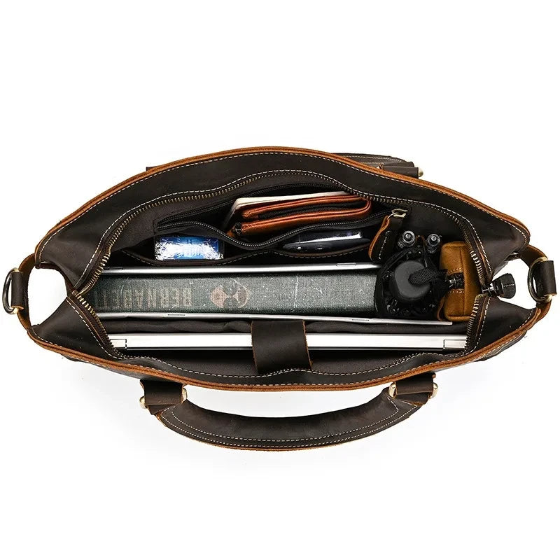 interior view of an organized leather bag, containing a laptop, wallet, documents and other essential items.