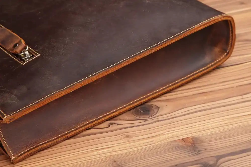 Close-up view of an elegant brown leather briefcase, highlighting its sophisticated design and handcrafted finish.