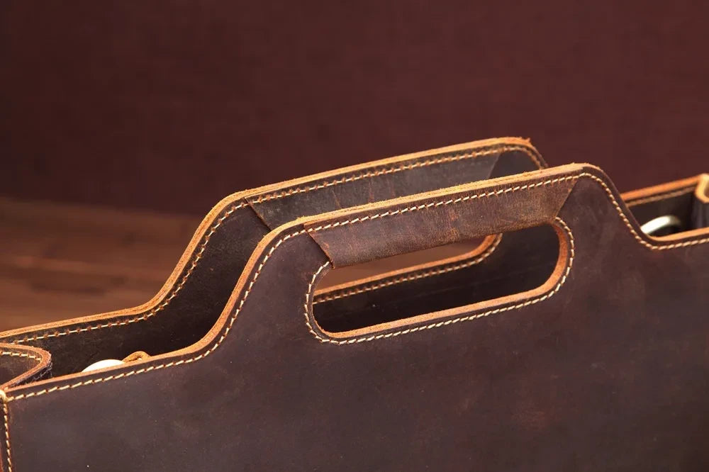 Close-up view of a brown leather bag handle with highlighted stitching and soft texture.