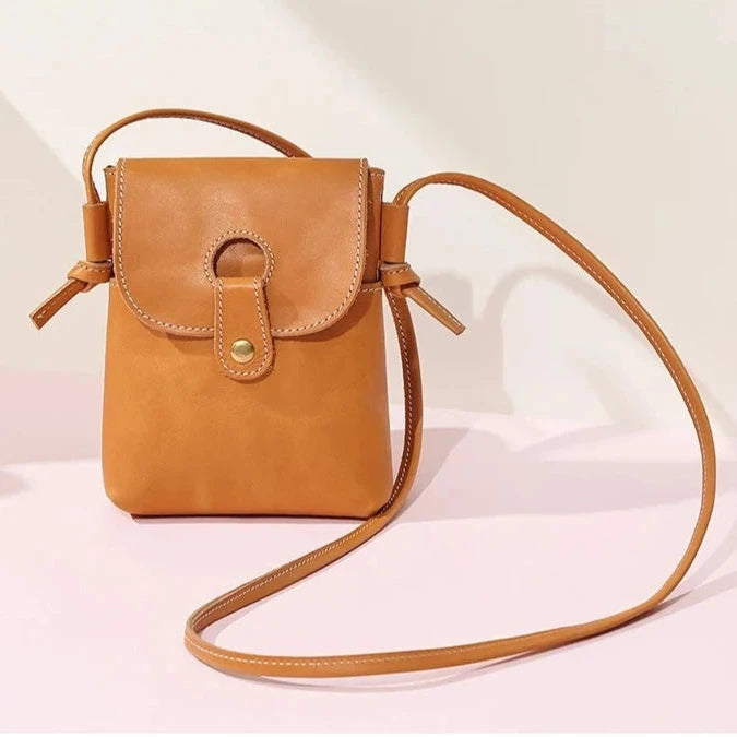 Brown women's leather crossbody bag, with long handle and elegant design - front view.