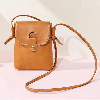 Brown women's leather crossbody bag, with long handle and elegant design - front view.