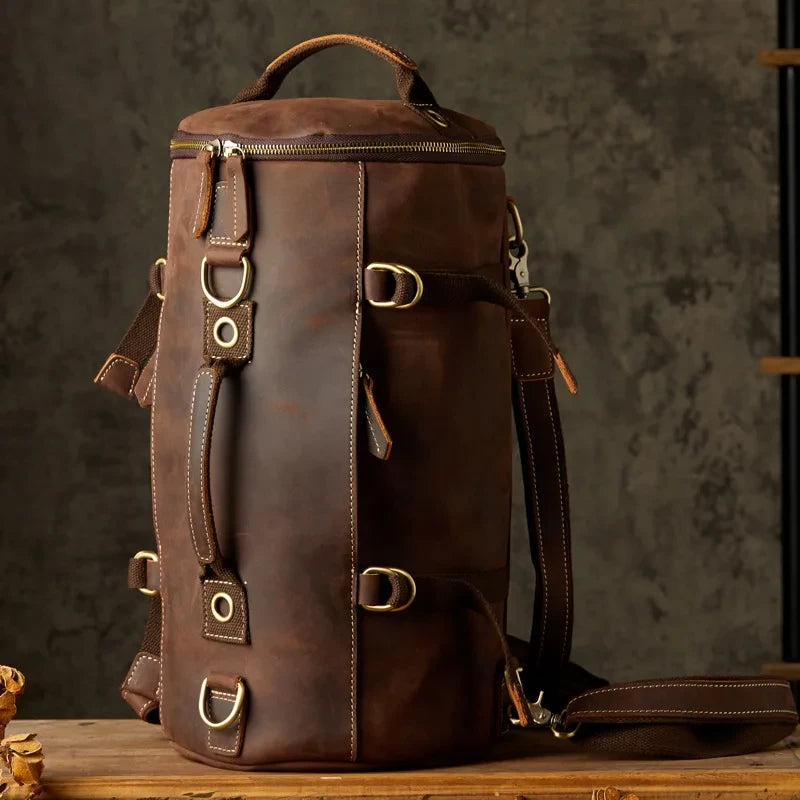 Brown leather duffle bag, with detachable straps and soft handles and a robust and versatile design, front view.