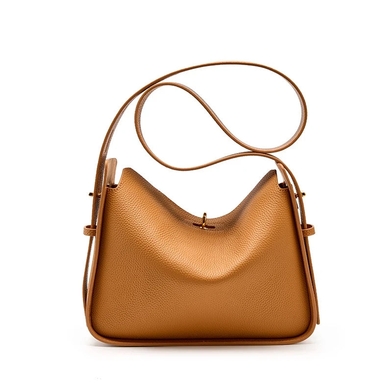 Elegant brown leather bag, with a modern design and long adjustable strap creating a casual look, front view.
