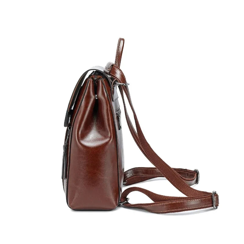 coffee brown leather backpack with adjustable straps and soft handle, side view.