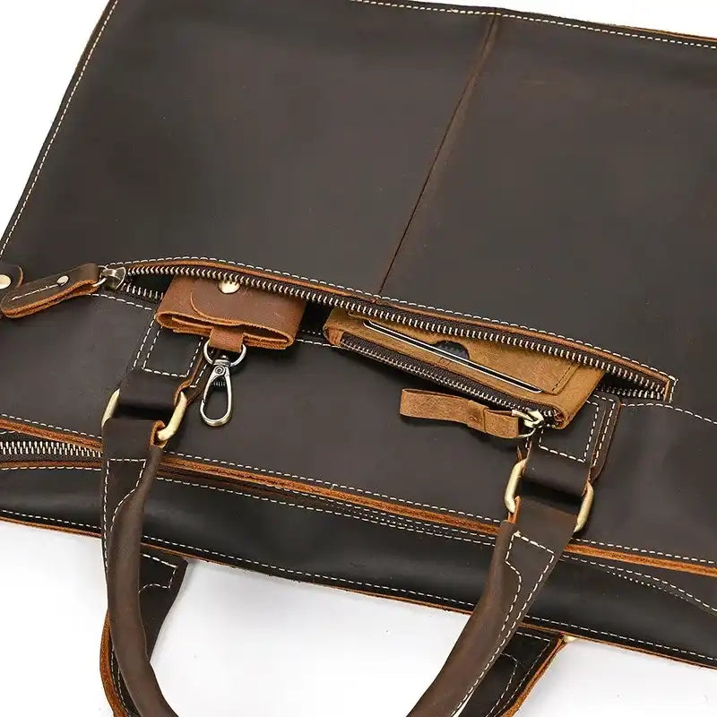 coffee brown leather suitcase with zipper and light stitching details, ideal for daily use and travel.