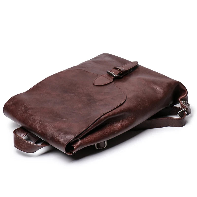 Vintage style coffee brown leather bag with adjustable straps and elegant buckle - top view.
