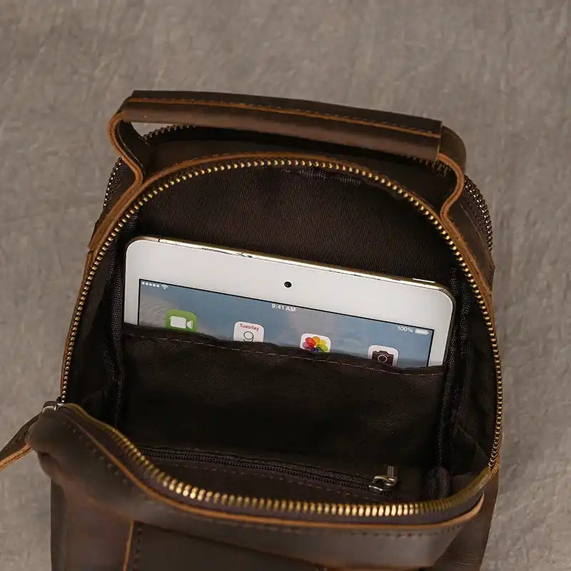 open leather bag with a tablet inside, highlighting practicality and style.
