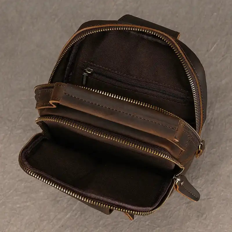 interior view of a brown leather bag with internal compartments and zipper.